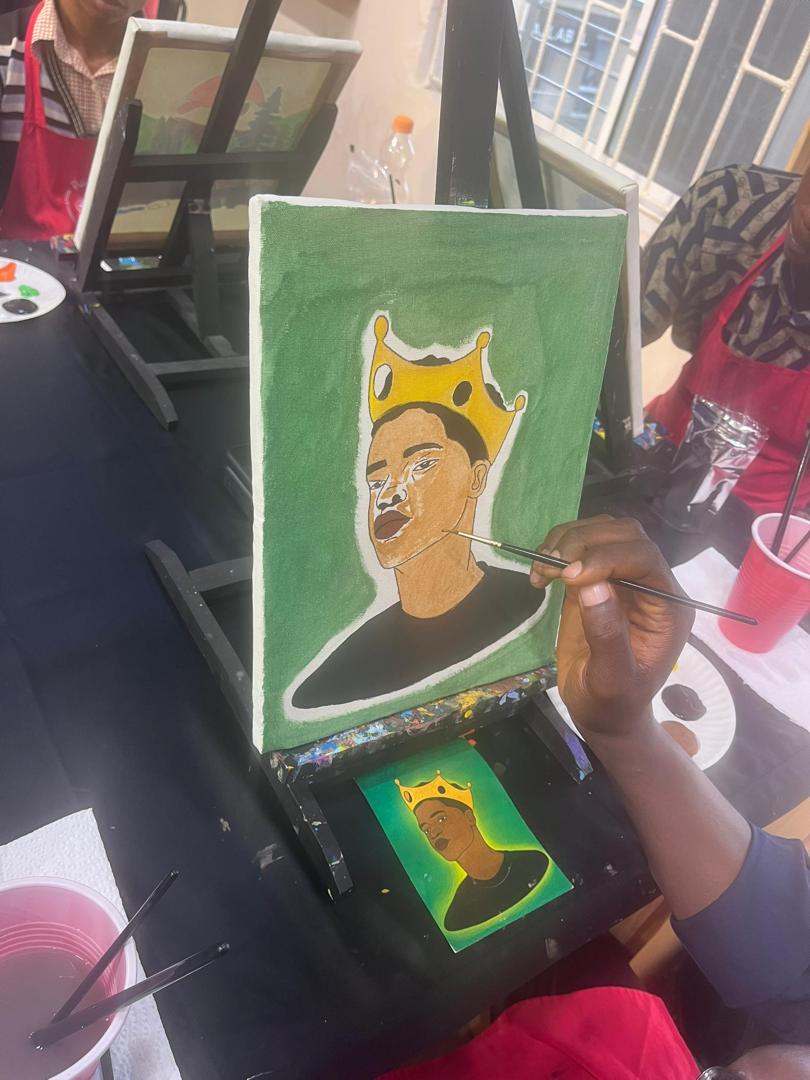 A scholar painting a portrait during the paint therapy session