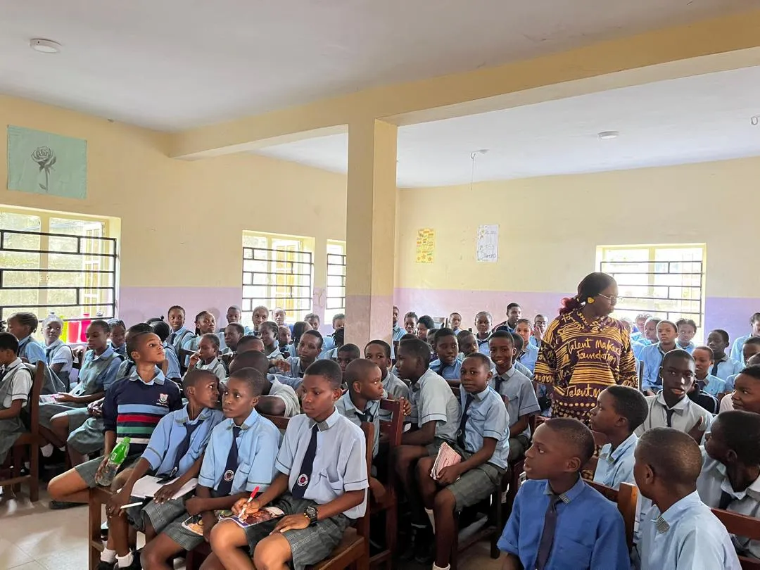 Students in blue and grey uniform during a classroom session with TMF staff