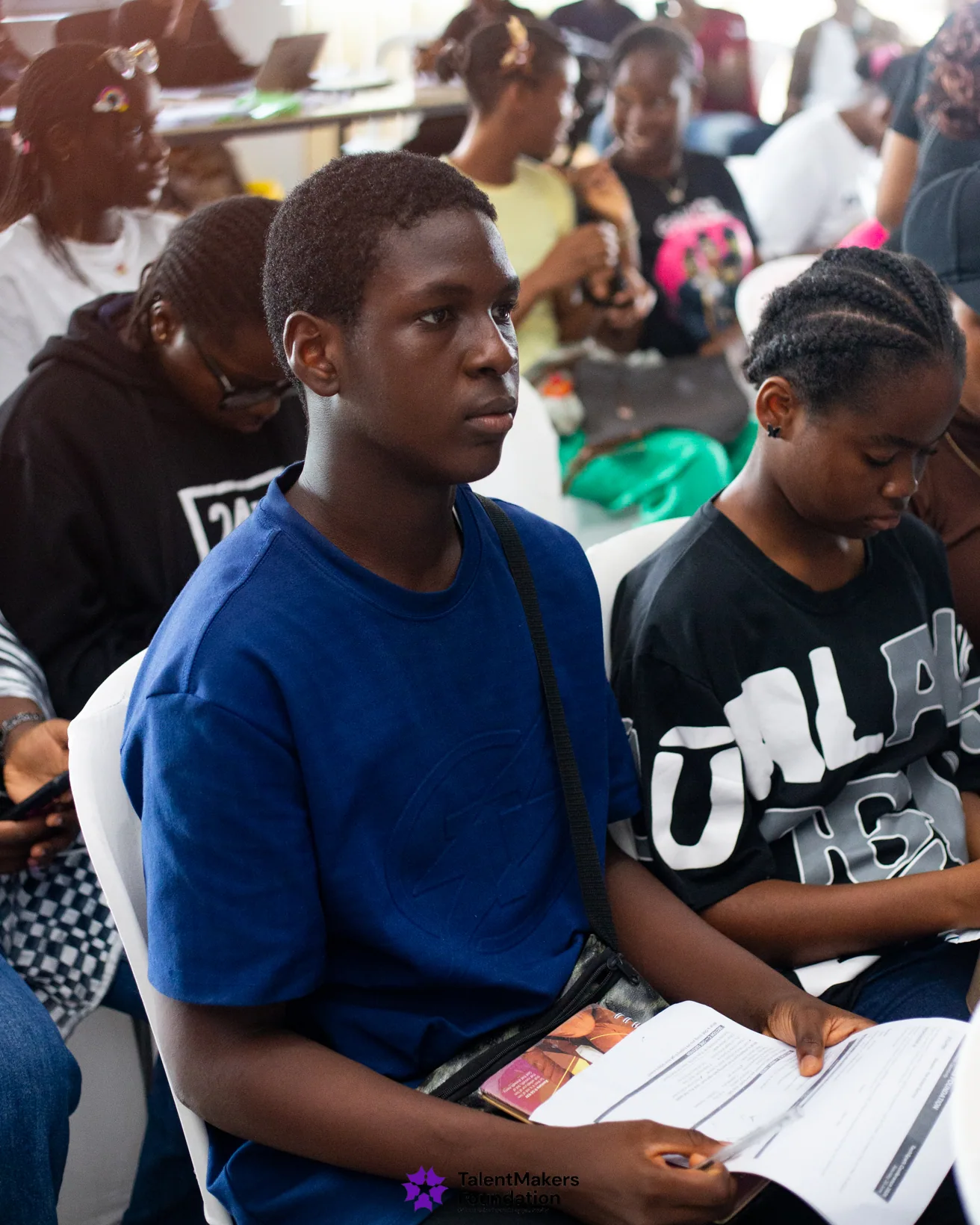 A student listening closely during a session at TechSpark 2026
