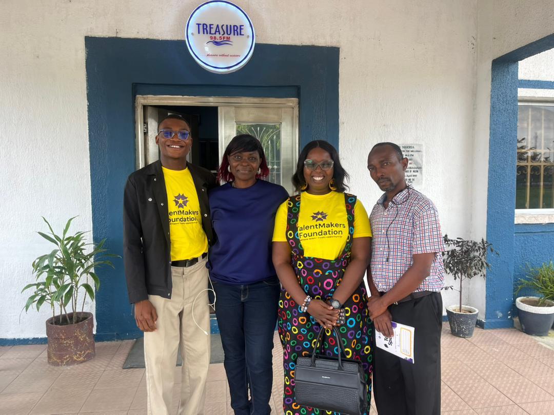 Scholars and staff outside the Treasure 98.5FM studio