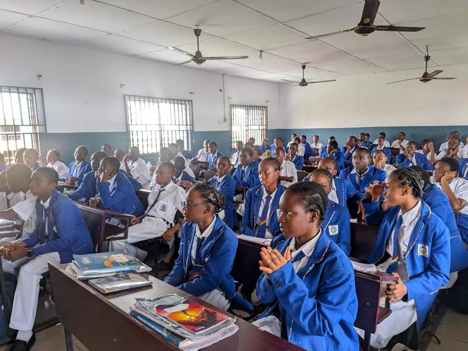 A full classroom of students in blue blazers giving their full attention during a TechSpark session