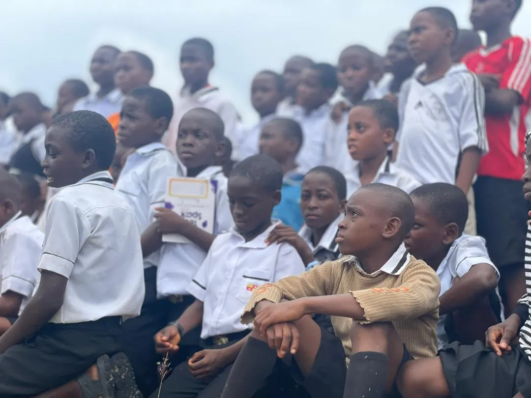 Students reading a TechSpark flyer closely during a school visit