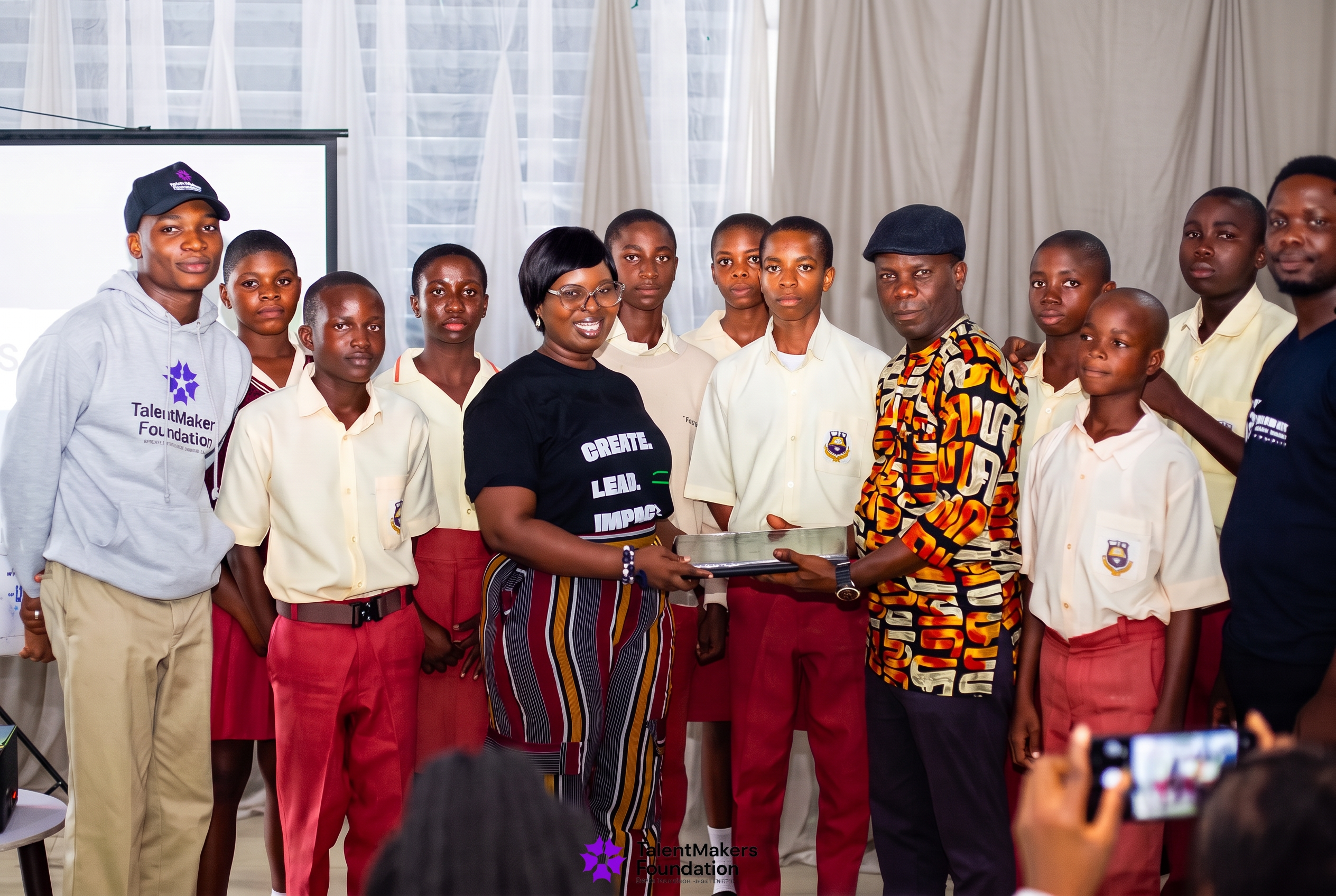 TalentMakers Foundation presenting a laptop to a partner school